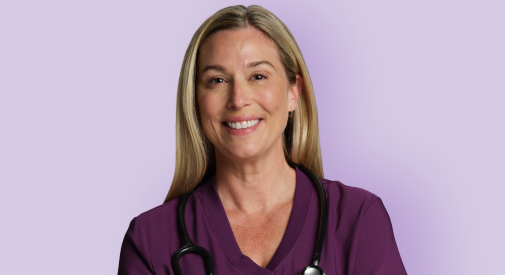Nurse smiling in burgundy scrub shirt with purple background