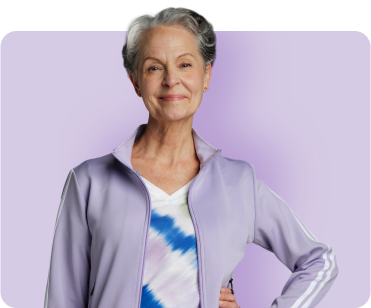 Woman in grey zip-up hoodie with purple background