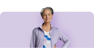 Woman in grey zip-up hoodie with purple background