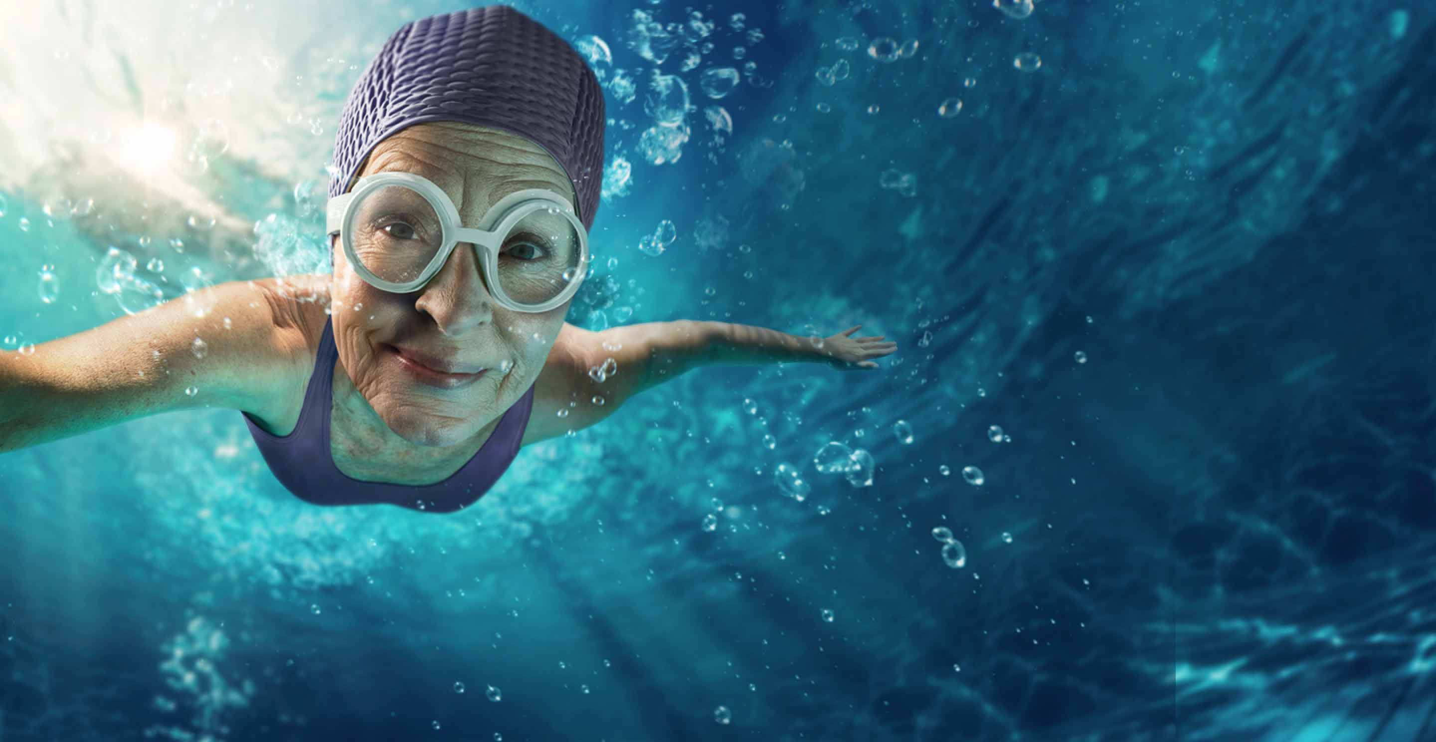 Woman swimming with purple bathing suit and water cap