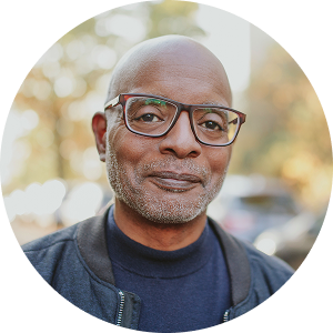 Male wearing a blue shirt and jacket