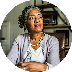 Woman looking to the side with white shirt and grey cardigan