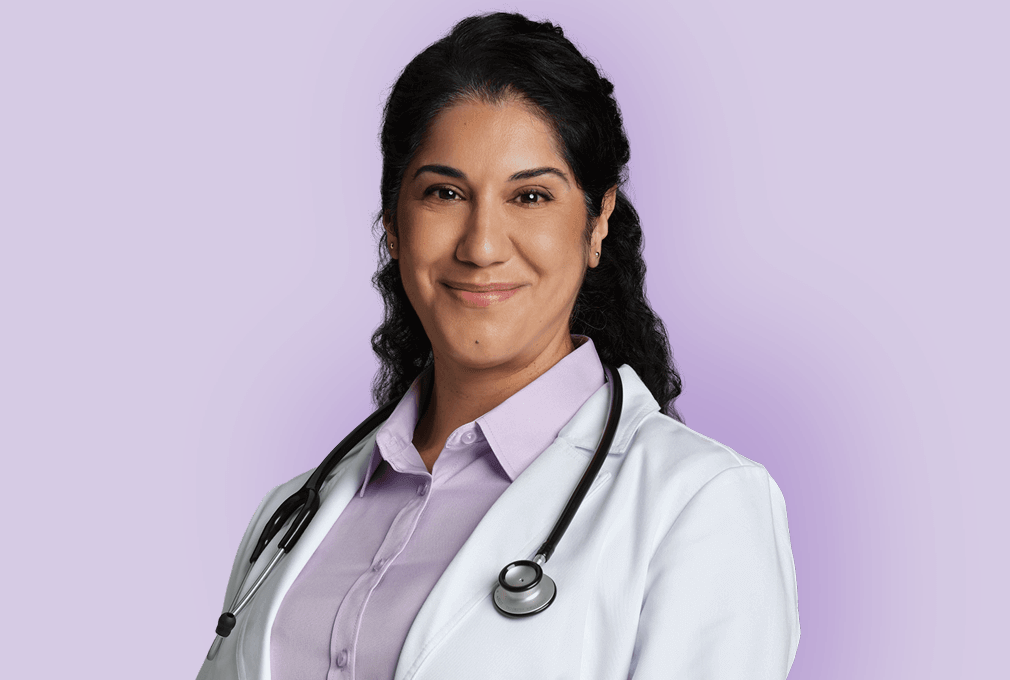 Female doctor with lab coat and stethoscope with purple background