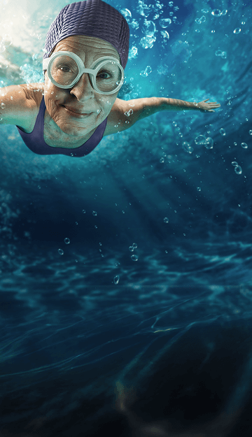 Woman swimming with purple bathing suit and water cap