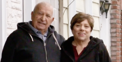 Man and woman in black hoodies smiling