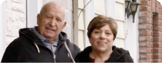 Man and woman in black hoodies smiling